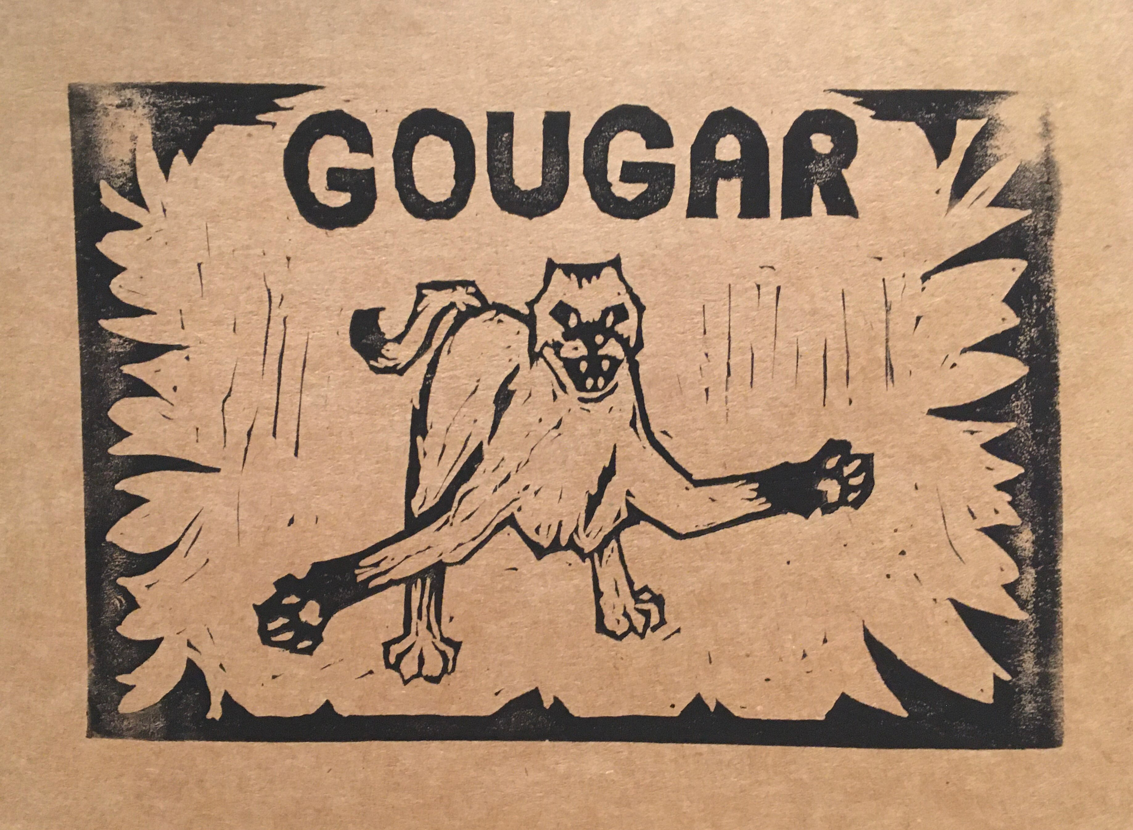 black ink blockprint on brown paper, depicting a cougar with arms outstretched and ears back, lunging forward. a rectangular border wraps around it, with curved spikes resembling fangs or claws reaching towards the middle. the title at the top reads “GOUGAR” in bold letters